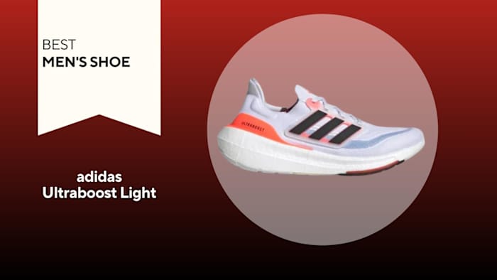 White adidas ultraboost light with black stripes and orange accents
